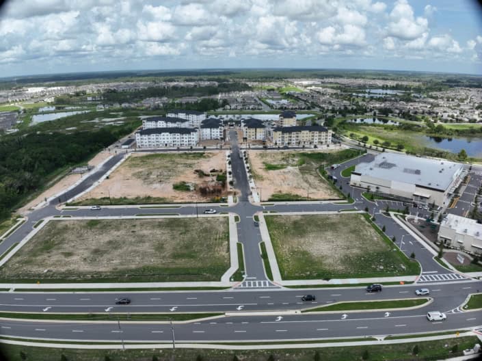 Empty lot development at SDC with new infrastructure and surrounding residential areas.