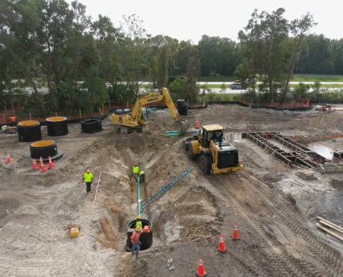 Excavation and foundation work on a commercial construction site demonstrating site development expertise and heavy machinery in action.