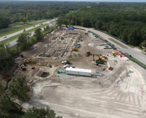 Drone view of ongoing site development for commercial construction in Florida, with heavy machinery and groundwork in progress, focusing on custom site development services.