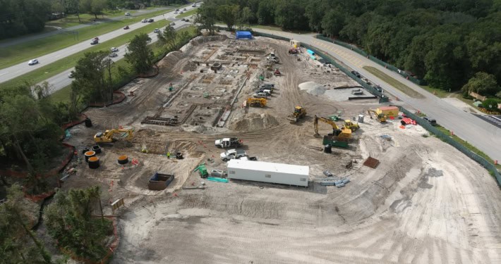 Drone view of ongoing site development for commercial construction in Florida, with heavy machinery and groundwork in progress, focusing on custom site development services.