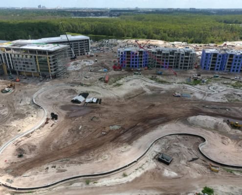 Construction site of modern residential or commercial buildings with ongoing development and infrastructure work in progress.