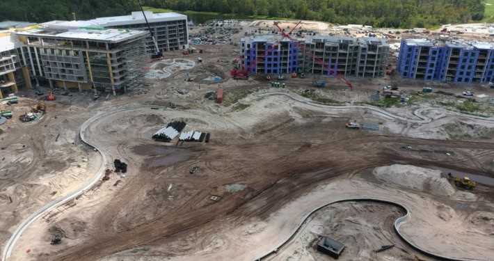 Construction site of modern residential or commercial buildings with ongoing development and infrastructure work in progress.