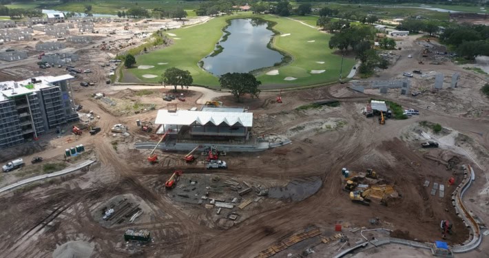 Modern golf course construction with water features and landscaping under development at a new residential community site.