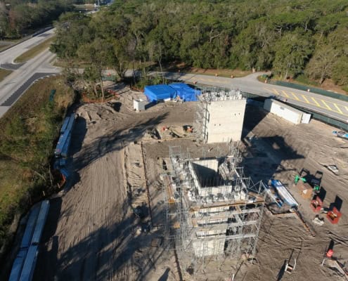 Modern commercial construction site with scaffolding, utility infrastructure, and groundwork organized for new development - SDC Site Development.