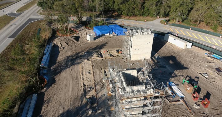 Modern commercial construction site with scaffolding, utility infrastructure, and groundwork organized for new development - SDC Site Development.