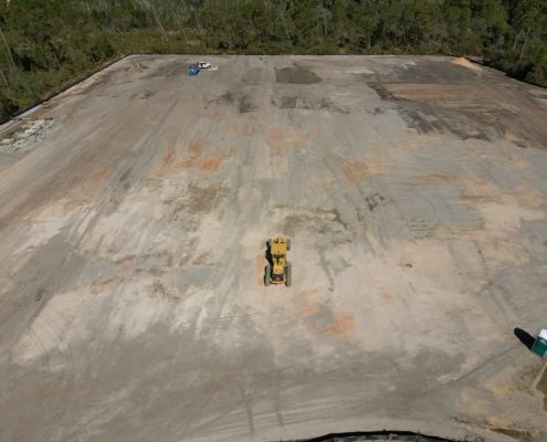 Excavation site for commercial development with heavy machinery preparing the foundation.