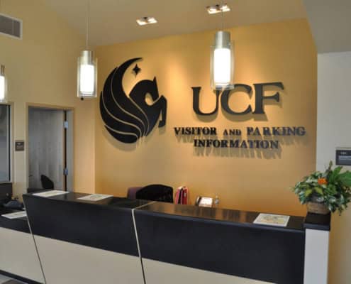 Modern visitor and parking information desk at UCF campus entrance.