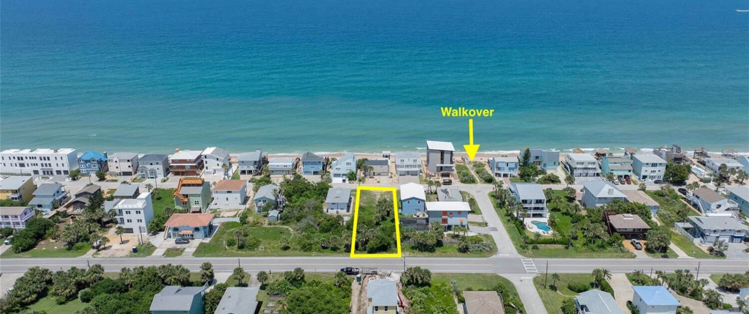 Aerial view of beachfront residential lot with walkover access in a coastal community, ideal for building a custom home near the ocean, featuring nearby amenities and scenic water views.